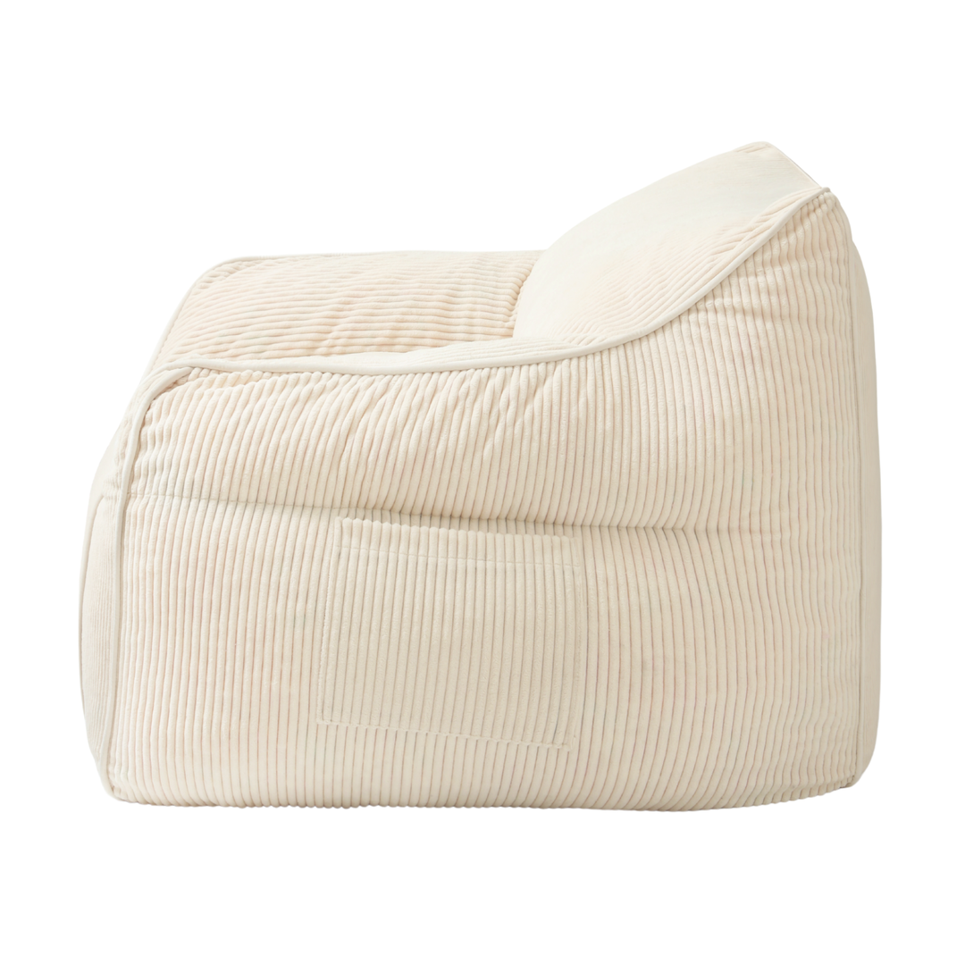 Pouf fauteuil enfant en velours côtelé blanc cassé, vue de profil avec accoudoir